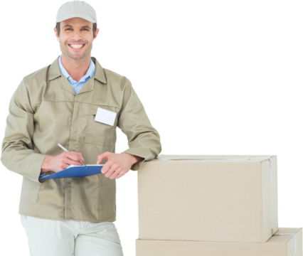 Happy delivery man writing on clipboard by cardboard boxes