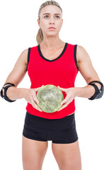 Female athlete with elbow pad holding handball