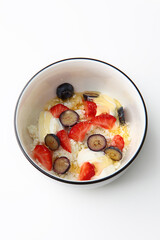 Cottage cheese with strawberry and blueberry, fresh berries, healthy breakfast concept, top view.Copy space.Isolated object.Vertical photo.