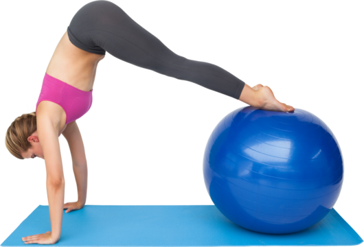 Side view of a fit young woman stretching on fitness ball