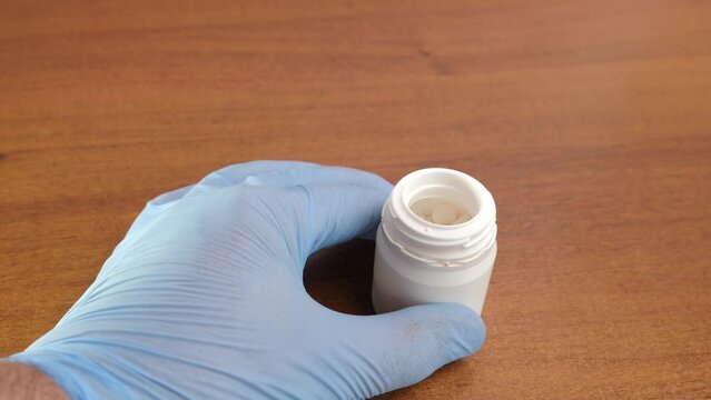 Tablets of potassium iodide are poured onto the hand. Radiation danger. Danger of overdose.