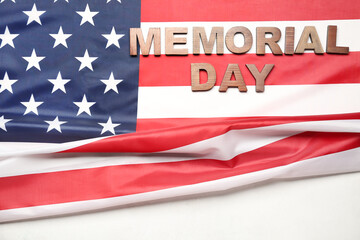 Fototapeta na wymiar Text MEMORIAL DAY with USA flag on white background