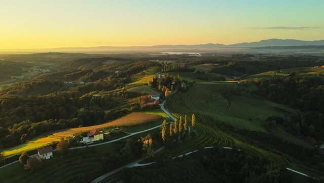 Aerial drone 4K footage of Prlekija in the morning during sunrise. Prlekija is a picturesque region in northeastern Slovenia known for its rolling hills, lush vineyards, and rich cultural heritage.