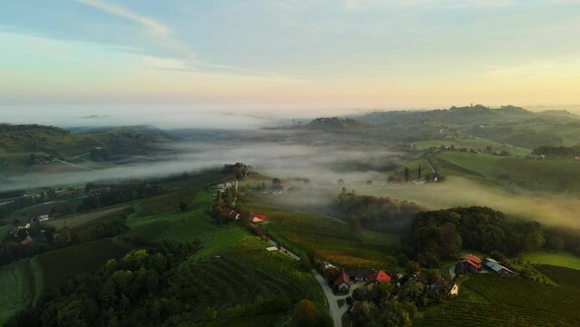 Aerial 4K drone footage of Kog during sunrise. It is a village in the hills northeast of Ormož in northeastern Slovenia, right on the border with Croatia.