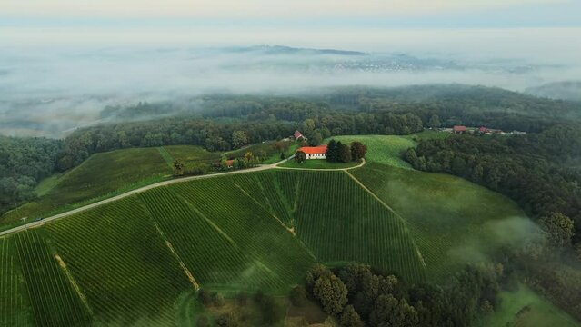 Aerial 4K drone footage of Železne dveri during the sunrise. It is a settlement in the wine hills south of Ljutomer in northeastern Slovenia near Jeruzalem.
