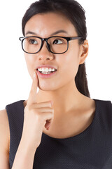Thinking businesswoman wearing glasses and smiling