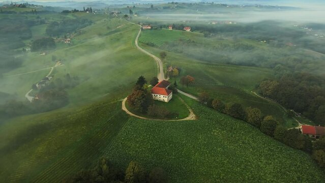 Aerial 4K drone footage of Železne dveri during the sunrise. It is a settlement in the wine hills south of Ljutomer in northeastern Slovenia near Jeruzalem.
