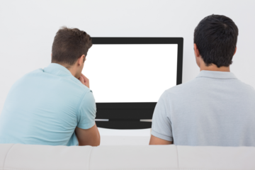 Two soccer fans watching tv