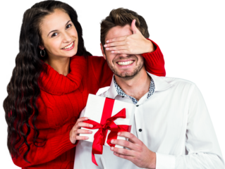 Young woman covering eyes of partner holding gift