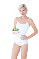 Beautiful fit woman holding a bowl of salad