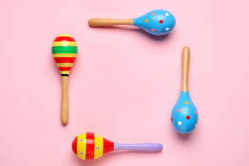 Frame made of Mexican maracas on pink background