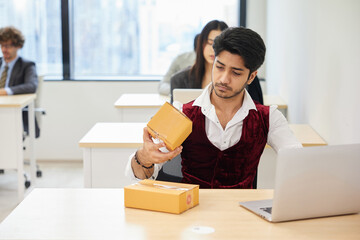 businessman checking parcel cardboard boxes from online shopping in the office