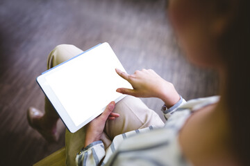 Low section of woman using digital tablet
