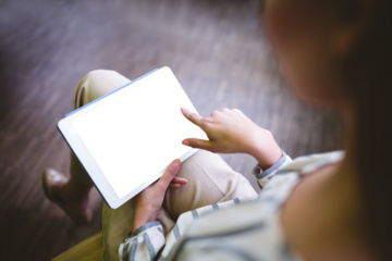 Low section of woman using digital tablet