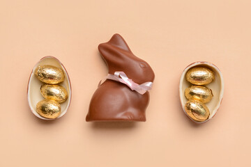 Chocolate bunny and Easter eggs on beige background