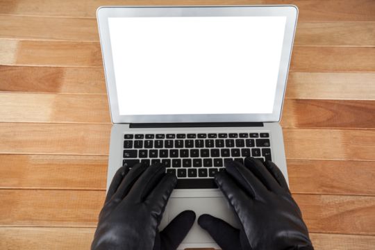 Cropped hands of hacker using laptop  - Powered by Adobe