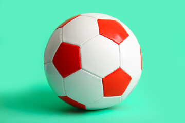 Fototapeta premium Soccer ball on turquoise background