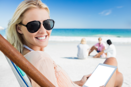 Smiling woman holding digital tablet