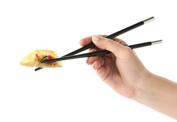 Woman holding tasty Chinese jiaozi with chopsticks on white background