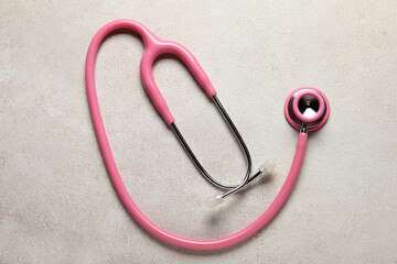 Modern stethoscope on light  background