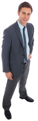 Cheerful businessman standing with hand on hip