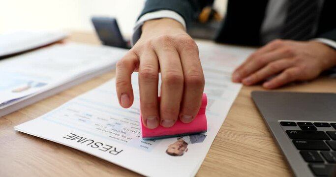 Manager hand stamping approved on employee resume in office closeup 4k movie slow motion. Employment concept 
