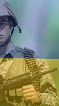 Animation of flag of ukraine over caucasian soldier with weapon