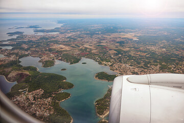 Aerial view through porthole of aircraft, flying over Thessaloniki,Croatia,Istria,Europe.View from airplane .Traveling concept background - 588660404