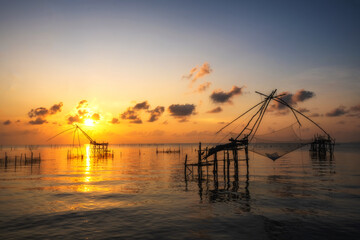 Naklejka na ściany i meble The wood of fish hunting with a sun rise view point on Thailand