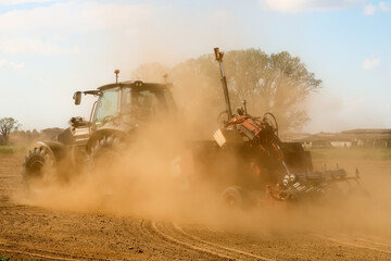 Tractor agriculture work field plow plowing land dust cloud drought climate change detail nature