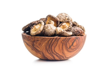 Dried shiitake mushrooms in bowl isolated on white background.