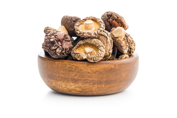 Dried shiitake mushrooms in bowl isolated on white background.