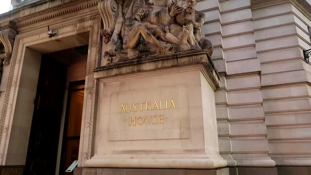 Tilt down revealing Australian High Comission facade and entrance with a big flag hanging. London