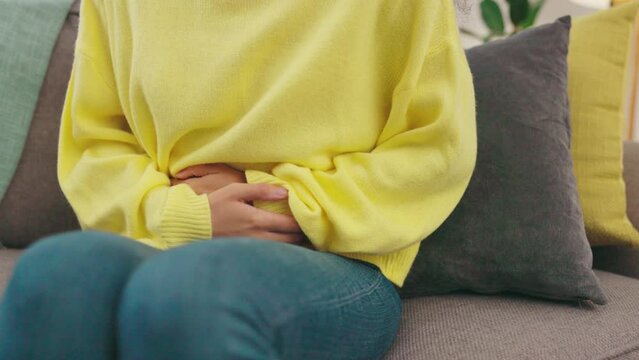 Woman, stomach ache and hands, period pain in menstrual cycle and healthcare with abdominal problem. Menstruation cramps, gut health and female at home with endometriosis, digestion issue and bloated