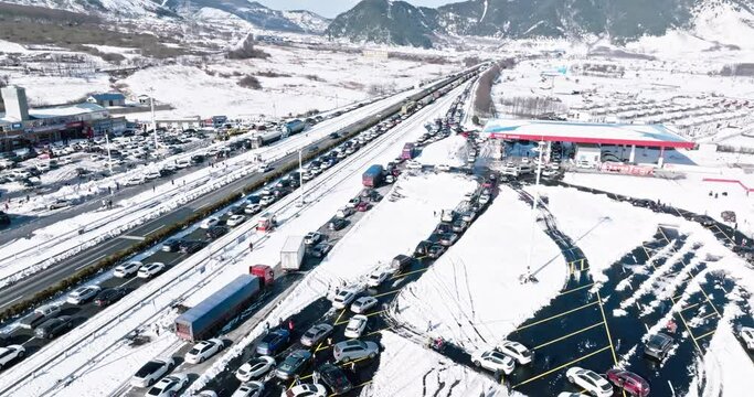 Aerial view of Heavy snow weather in winter leads to large-scale traffic jams on the expressway and long motorcades line up in the snow