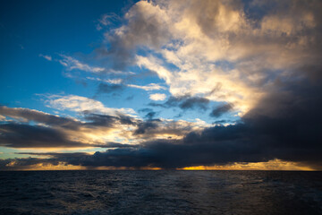 Rays of light at sunset in the ocean. Sunset sky.