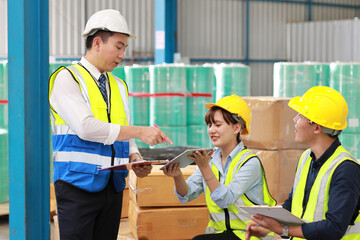 Group of technician engineer and businessman in protective uniform standing and discussing, researching, brainstorming and planning work together with tablet at industry manufacturing factory