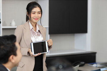 Collaborative process of professional businesspeople going over on new project together, using tablet presentation and brainstorming ideas, coworker and working together at office meeting concept