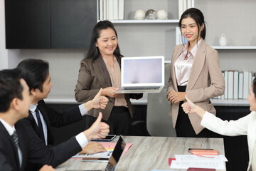 Collaborative process of professional businesspeople going over on new project, using paperwork and computer presentation with brainstorming ideas, coworker and work together at office meeting concept