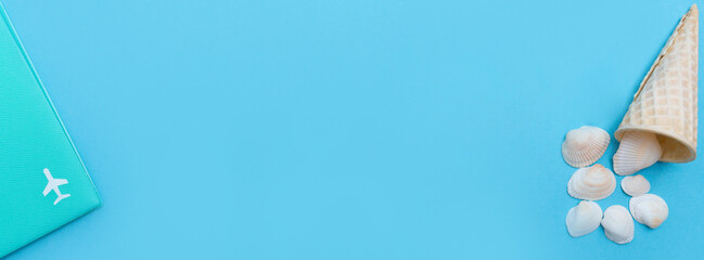Vacation and rest time. Banner with a passport with an airplane and an ice cream cone with seashells. Copy space. Place for text. Blue background. Top view. Flat lay.