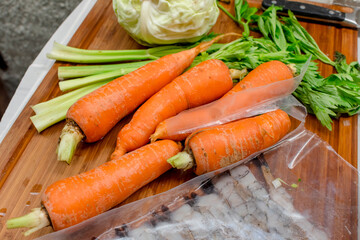 Carrots, cabbage, celery and other ingredients on the chopping board for Pancit Cabagan.