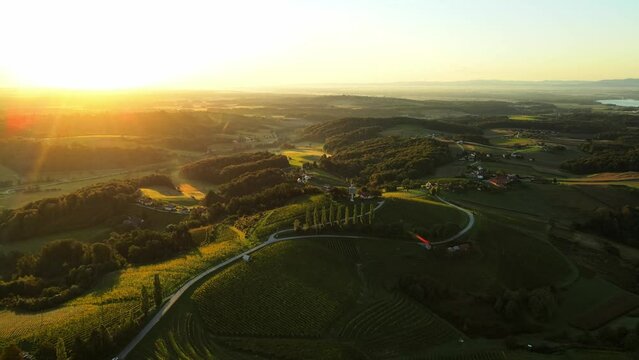 Aerial drone 4K footage of Prlekija in the morning during sunrise. Prlekija is a picturesque region in northeastern Slovenia known for its rolling hills, lush vineyards, and rich cultural heritage.