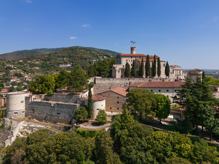 Fototapeta na wymiar Panoramic drone view of the western part of the historic castle on a hill (colle Cidneo) in the city of Brescia. Lombardy, Italy