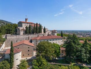 Fototapeta na wymiar Panoramic drone view of the western part of the historical castle in the town of Brescia and the surrounding old park. Lombardy, Italy