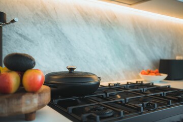 Modern kitchen with fruits by a black cooktop