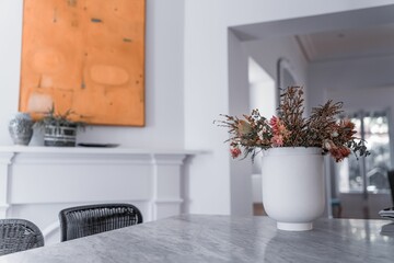 Modern kitchen with a vase with flowers on a gray marble table