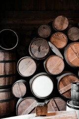 Vertical shot of stack of old wine barrels in the wooden basement
