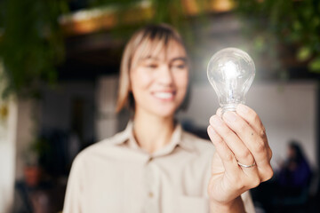 Lightbulb, happy and a woman with light from inspiration, knowledge or ideas at work. Smile,...