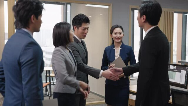 Successful business people shaking hands in office,4K