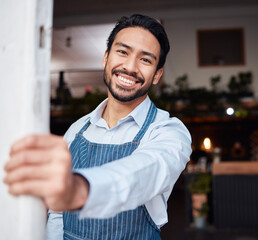 Happy, portrait and male entrepreneur of a cafe standing by the door to welcome customers. Confident, proud and face of a young man small business owner with success at his modern startup coffee shop